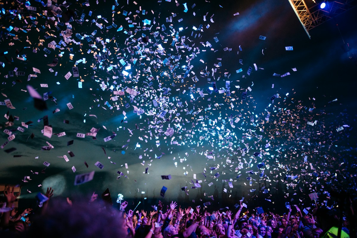 An entertainment event with stage lighting and an audience
