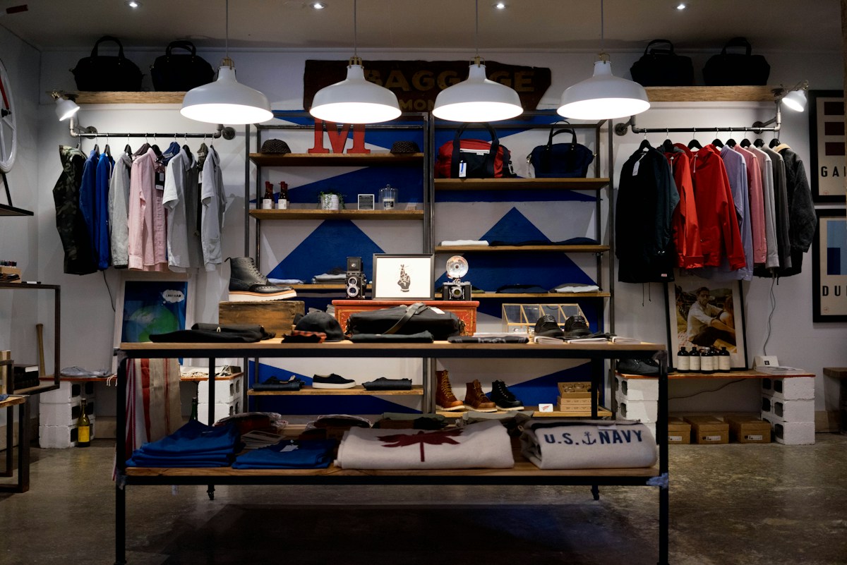 Retail shop interior with products displayed on rails and shelves